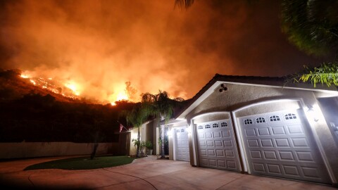 The Holy Fire burns near homes in the Cleveland National Forest in Lake Elsinore, Calif., Thursday, Aug. 9, 2018. (AP Photo/Ringo H.W. Chiu)
