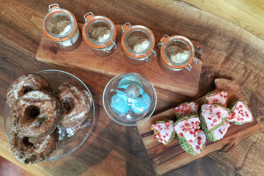 A quartet of tea-infused treats. Clockwise from left: Pastry chef's Naomi Gallego's old-fashioned doughnuts, flavored with Earl Grey; chocolate custard infused with jasmine tea, topped with a whipped cream ganache with a bit of lemon; berry scones with a hint of black berry tea; and blue French-style macarons made with lapsang souchong.