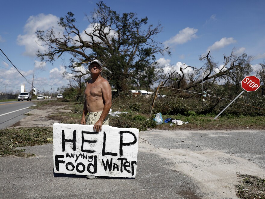 Michael Williams, 70, looks for help from passing motorists as downed trees prevent him from driving out of his damaged home in Springfield, Fla., in the aftermath of Hurricane Michael on Thursday. "I don't know what I'm going to do," he said.