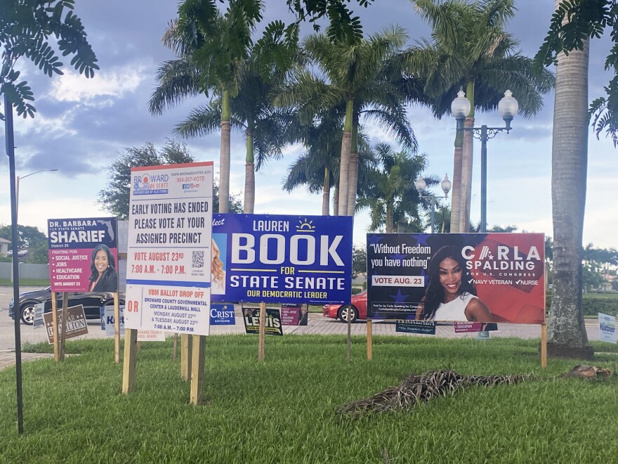 A Broward County sign at left informs voters they can't vote at this early voting library in Miramar, but many overlooked it and came anyways.