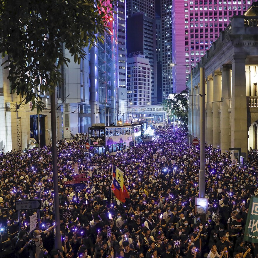 People light up their smartphones as they take part in a rally in Hong Kong's financial district on Wednesday.