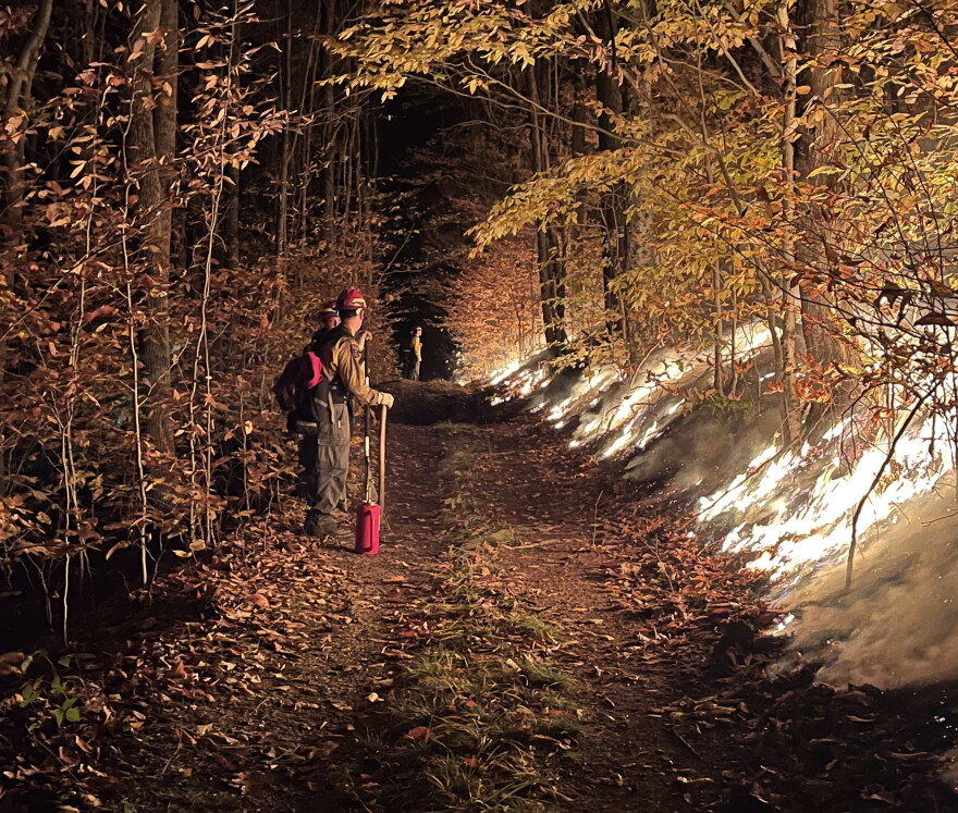 Fire crews worked overnight Monday to limit the wildfire's spread with controlled burns.