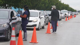  Drivers line up for COVID-19 tests on Tuesday, Dec. 21, 2021, in North Miami.