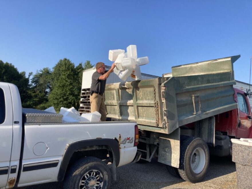 A Dubois County resident recycles triple-rinsed pesticide jugs at an annual agricultural recycling day.