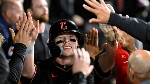 Cleveland Guardians' Travis Bazzana celebrates in the dugout after he scored during the ninth inning of a baseball game against the Chicago White Sox, Monday, June 22, 2026, in Chicago. 
