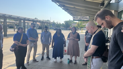 Members of We Make Indiana say a prayer at the Transpo transfer station downtown South Bend on Thursday, as part of their press conference urging Microsoft to pay into a community fund as they build their Granger data center.