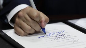 Florida Gov. Ron DeSantis signs a bill during a signing ceremony at the William J. Kirlew Junior Academy, Thursday, May 9, 2019, in Miami Gardens, Fla. DeSantis is expected to sign a bill prohibiting anti-Semitism in public schools during a trip to Israel.