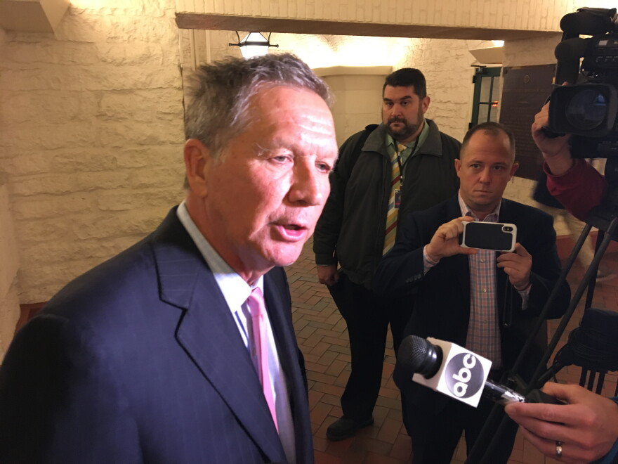 Gov. John Kasich talks to reporters after the opening of an exhibit featuring Ohio's two constitutions.