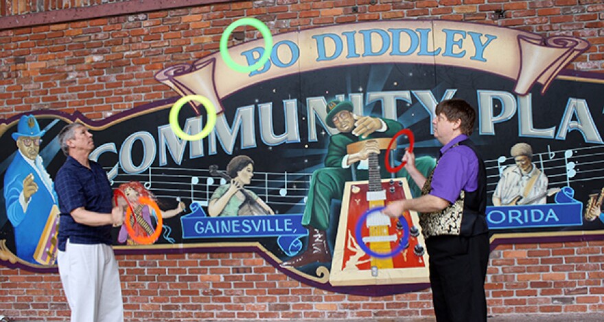 They are the Jongleur Jugglers and they will be performing at Jest Fest. In the pics that I sent they were practicing out on the Bo-Diddley Plaza. The guy in the vest is Michael Stillwell, AKA Magic Mike, and the other guy is John Creveling.