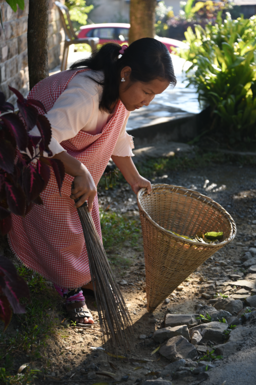 Resident Shidamon Kharrymba has help put Mawlynnong on the map as part of a team of women the village council has employed to clean up the common areas of the village each day. She carries the wicker dustbin that has become the emblem of Mawlynnong. Tourists snap up miniature versions of the baskets for mementos.