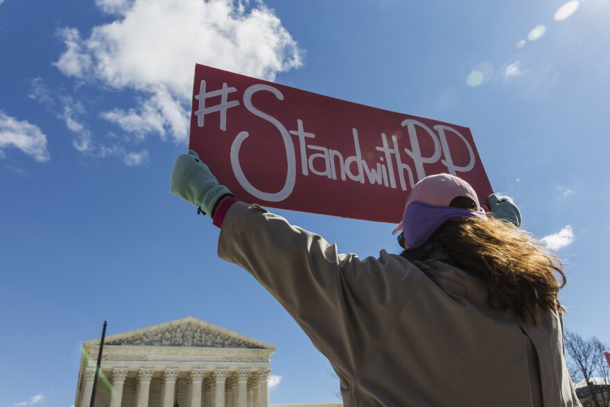 A protester shows her support for Planned Parenthood outside the Supreme Court Building in March