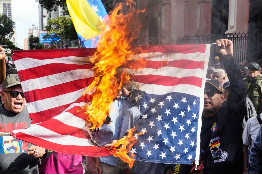 Government supporters burn a U.S. flag in Caracas, Venezuela, Saturday, Jan. 3, 2026, after U.S. President Donald Trump announced that U.S. forces had captured Venezuelan President Nicolás Maduro and his wife.