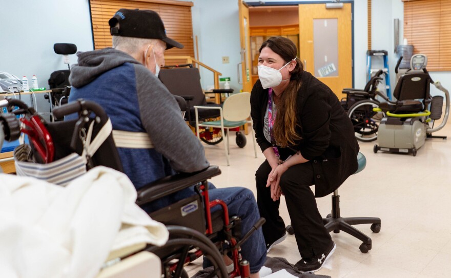 Amanda Eldridge, a certified occupational therapist assistant, works with a veteran at the state-run St. James Veterans Home in St. James, Missouri.