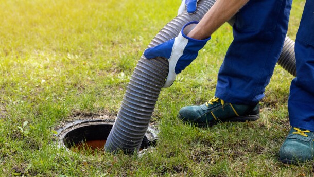 Man pumping out house septic tank.