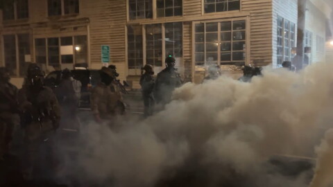 Federal officers spray and throw chemical gases at demonstrators a block up from the ICE processing facility south of downtown Portland on Saturday, Oct. 5, 2025.