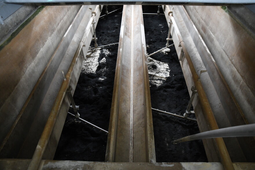 Some granular activated carbon remains at the bottom of a filtering pool as it's being replaced. Ann Arbor's drinking water is filtered through carbon to capture impurities such as PFAS. The carbon must be frequently replaced, at significant cost that's ultimately paid by customers.