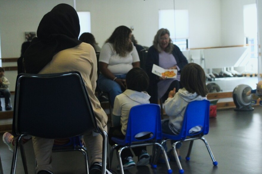 Kids listen to stories read in both English and Spanish at the Arlington Street Community center in Nashua on Thursday, Oct. 2, 2025. 