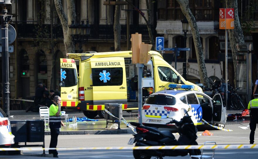 Emergency personnel cordon off the area where a van plowed into a crowd on Las Ramblas boulevard in Barcelona on Thursday.