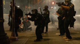 Police use tear gas and impact munitions to disperse protesters in downtown Portland, Ore., during 4th of July demonstrations against systemic racism and police violence.