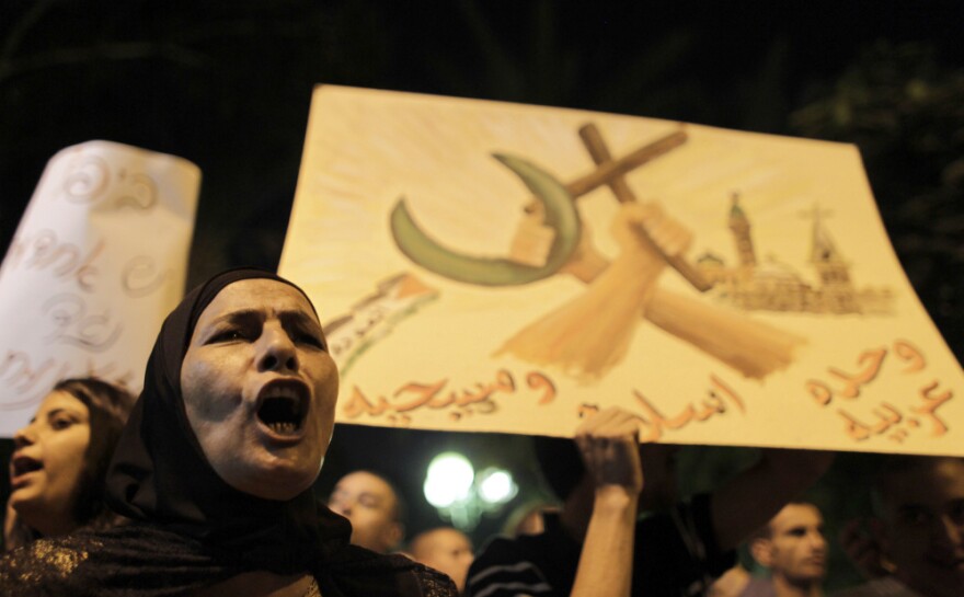  A woman shouts slogans during a demonstration against the desecration of headstones at a Muslim and Christian cemetery in Jaffa, Israel, last month. A few dozen Israelis and Palestinians turned out in a show of protest against recent attacks. 