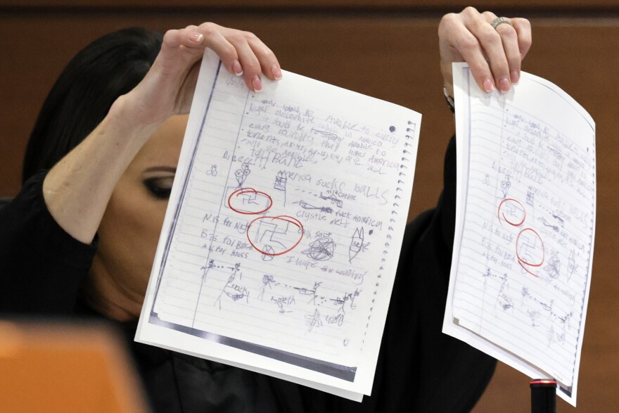 Judge Elizabeth Scherer holds up copies of Parkland shooter Nikolas Cruz's class assignments as she considers whether the jury should be prevented from seeing the swastikas on the pages at the Broward County Courthouse in Fort Lauderdale, Fla., on Thursday, Sept. 1, 2022. 