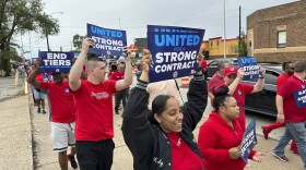 United Auto Workers members march while holding signs at a union rally held near a Stellantis factory Wednesday, Aug. 23, 2023, in Detroit. UAW President Shawn Fain told reporters that bargaining on a new contract is not going well between the UAW and Detroit's three automakers. (AP Photo/Mike Householder)