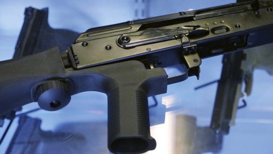 In this file photo, a device called a "bump stock" is attached to a semi-automatic rifle at the Gun Vault store and shooting range in South Jordan, Utah.