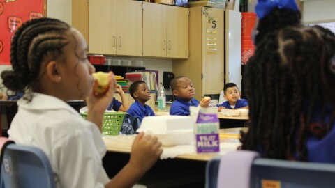 Children eat breakfast on the first day of school in New Orleans on Aug. 4, 2025.