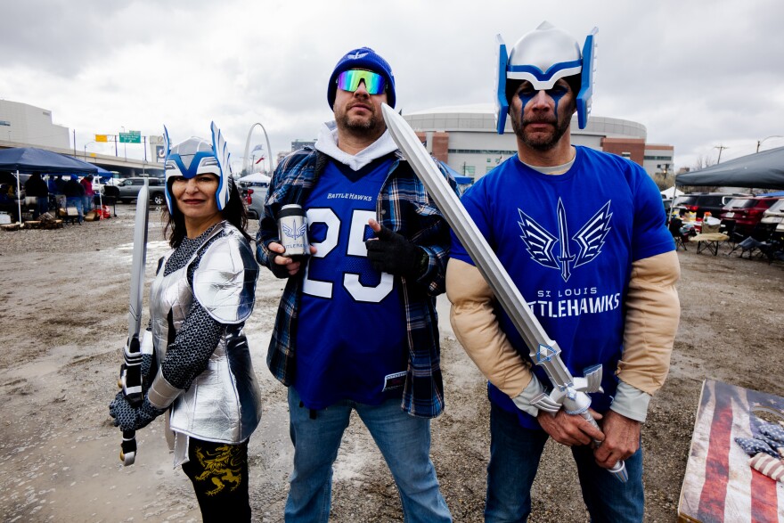 Serena Hunter, 49, of Edwardsville, Jeremy Hunter, 42, and Chris Hunter, 47, both of Granite City, show off their St. Louis Battlehawks gear on Sunday, March 12, 2023, the team’s inaugural matchup against the Arlington Renegades in downtown St. Louis.