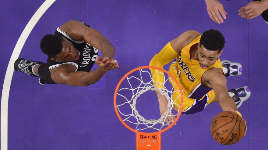 Los Angeles Lakers guard D'Angelo Russell (right) shoots as Brooklyn Nets forward Thaddeus Young leaps for the block during a game in March in Los Angeles.