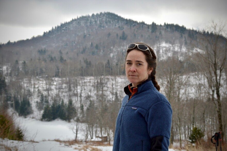 Kate Wanner of the Trust for Public Land photographed outside with a snowy mountain backdrop.