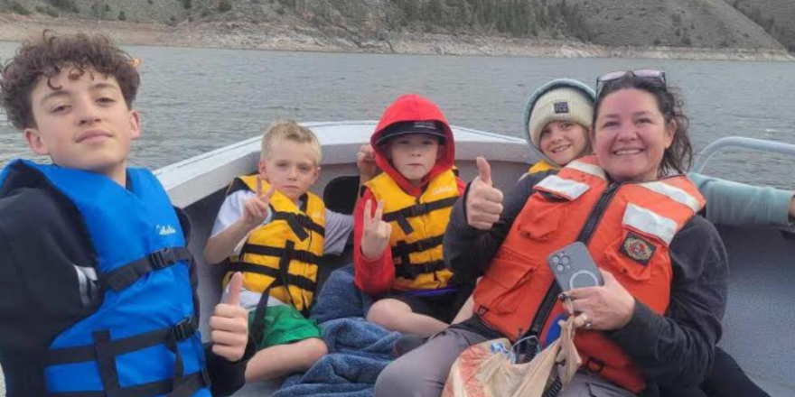 Members of the Sedler family and friends taking a boat home from school in Gunnison to Cimarron following Thursday's closure of I-80 at Blue Mesa Reservoir.