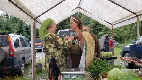 Zuba Dorvell (left) places a crown and cape on Jennifer Castellani at the Zucchini Fest at the Homer Farmers Market on Saturday, Aug. 26 in Homer. Castellani is the first queen crowned since the last festival in 2019.