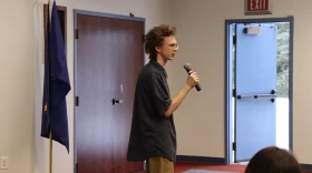 KCHS junior Gavin Hunt addresses his fellow classmates at the Kenai Chamber's job shadow luncheon. (Hunter Morrison/KDLL)