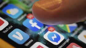 FILE - A smartphone displays the apps for Facebook and Messenger, both owned by Meta. (AP Photo/Jenny Kane, File)