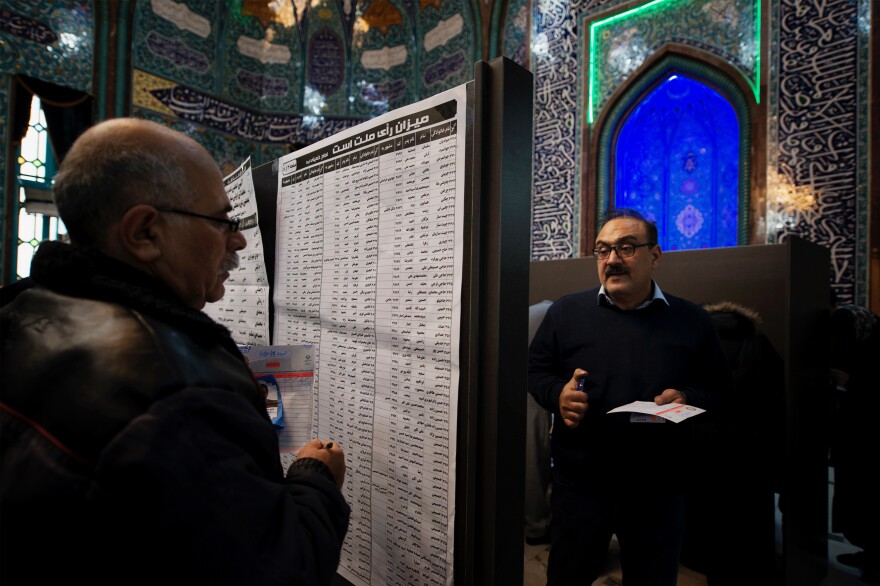 The lists of candidates are placed on a board in the middle of Hoseyniye Ershad, one of the main voting locations in Tehran. More than 7,000 candidates are hoping to win spots in Iran's 290-seat parliament.