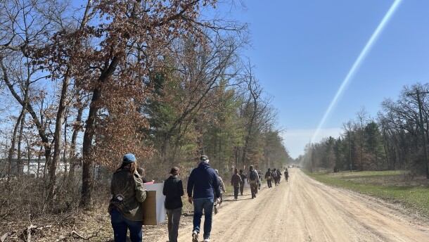 People marching along the perimeter of North Lake Processing Center, the 1,800-bed ICE detention center in northern Michigan, in support of detainees on a hunger strike on April 21, 2026. (Photo: Claire Keenan-Kurgan/IPR News)