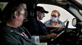 Workers bring their resumes to a drive-thru job fair in Elkhart during the pandemic.