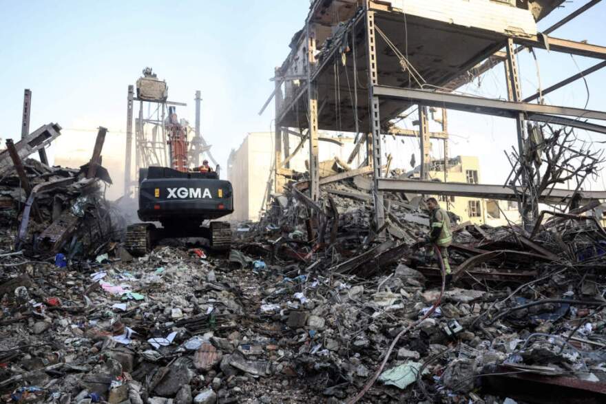 A firefighter stands on the rubble of residential buildings near Niloufar square in Tehran during the ongoing joint US-Israeli military campaign on Iran on March 2, 2026. The United States and Israel launched strikes against Iran on February 28, killing Iran's supreme leader and top military leaders, prompting authorities to retaliate with strikes on Israel and across the Gulf. (AFP via Getty Images)