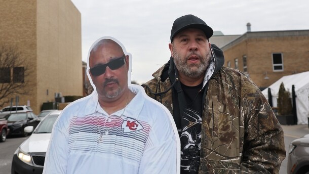 Robert Olson poses with a cardboard cutout of his friend Owen Ramsingh.