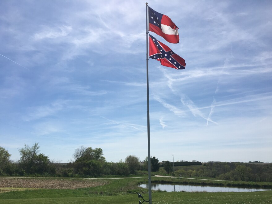 Two different variations of Confederate flags fly in Owen Golay's yard in rural Pleasantville, Iowa.