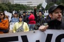 People chant during a protest at Houston City Hall over recent fatal shootings by U.S. Immigration and Customs Enforcement on Jan. 10, 2026.