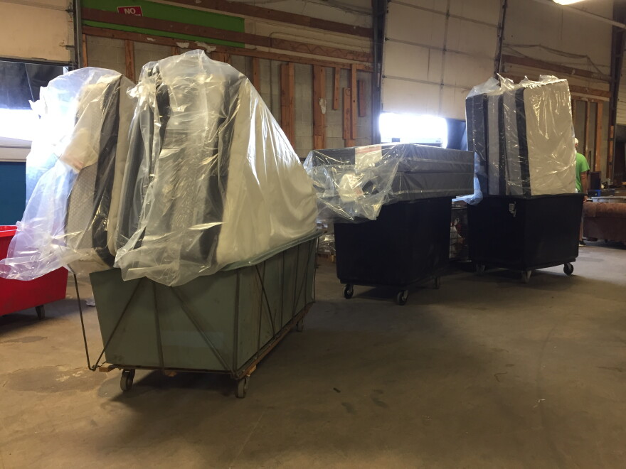 Mattresses line up at a loading dock. Volunteers continue furniture deliveries to families displaced by the Memorial Day Tornadoes.