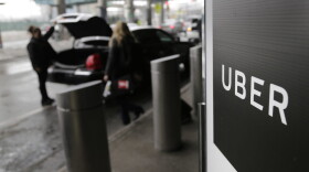 In this March 15, 2017, file photo, a sign marks a pick-up point for the Uber car service at LaGuardia Airport in New York. Travis Kalanick, the combative and embattled CEO of ride-hailing giant Uber, resigned under pressure from investors at a pivotal time for the company. (Seth Wenig/AP)