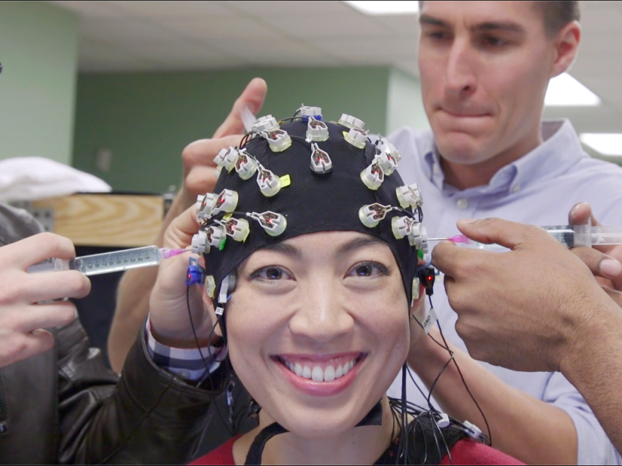 Elise getting gel injected into a brain bonnet.