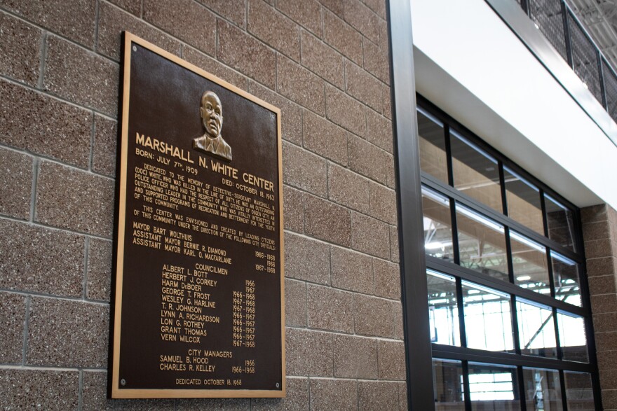 A plaque from the dedication of the original Marshall White Center is on the wall inside the new building, May 20, 2026