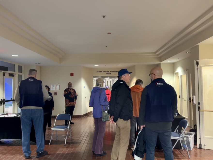 The lobby of the Irvine Auditorium on the Middlebury Institute for International Studies campus. It's filled with a group of eight people.