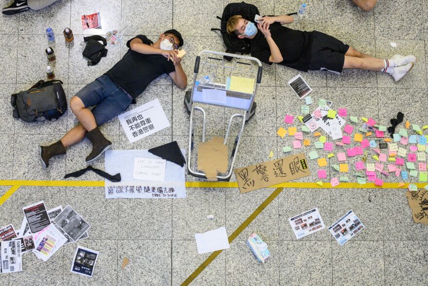 Protesters rest at the airport in Hong Kong.