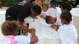 Students and volunteers painting new concrete bump-outs on Rockdale Ave. in front of Rockdale Academy.