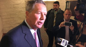 Gov. John Kasich talks to reporters after the opening of an exhibit featuring Ohio's two constitutions.